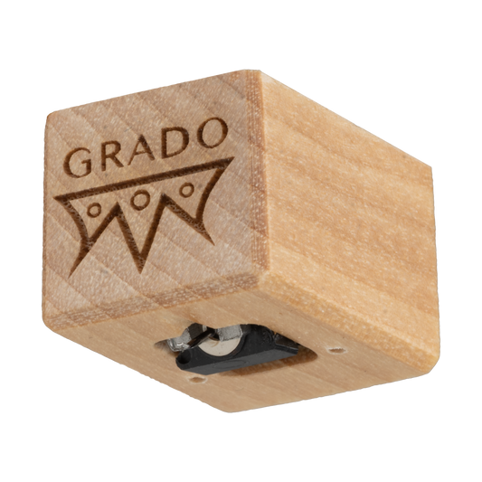 Close up photo of a Timbre Series - Opus - Cartridge which is wooden and has the words GRADO and a symbol that resembles an upside down crown engraved in it.